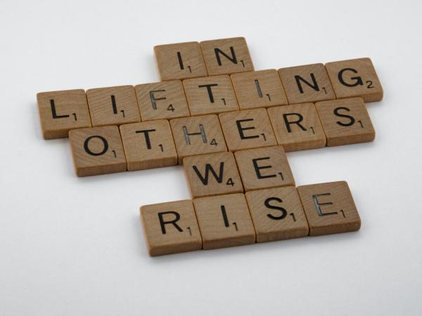 In-Lifting-Others-Photo-by-Brett-Jordan-on-Unsplash Scrabble letters spell out "In lifting others, we rise." Photo by Brett Jordan on Unsplash.